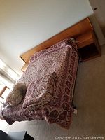 Side view of assembled headboard, nightstands, bed frame with quilt
