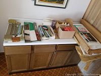Full overview photo showing all Oriental craft supplies on a cabinet including brushes, papers, inks, paints, stamps, and pencils.