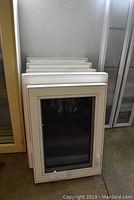Stack of five white vinyl windows including casement, double-hung, and slider types