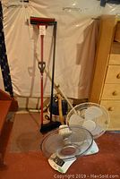 Lot showing the Hitachi vacuum, two fans, and Vileda mop placed in a room with plastic-covered wall and furniture nearby.