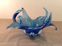 Ice blue glass centrepiece with flowing, curl-like petals.