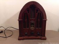 Front view of vintage GE bee hive style AM/FM radio in wooden case
