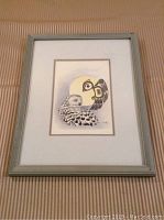 Full view of framed snowy owl print with some visible frame wear
