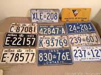 Lot of 11 vintage license plates mainly from Ontario with signs of use and aging, one yellow Knights of Pythias plate included.