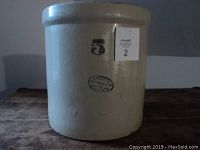 Front side of the beige Medalta stoneware crock showing the '5' capacity mark and oval Medalta stamp.