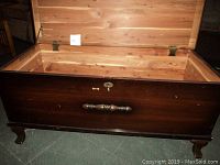 Front and interior of solid wood hope chest showing cedar lining and pedestal feet.