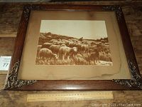 Framed sepia photo showing entire frame and photo mounted on cardboard with water damage visible at corners and edges.