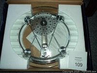 Glass personal scale in original box with white foam packaging, clear glass platform and round mechanical dial.