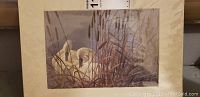 Signed lithograph of swans with reeds, 11x14 inches, in protective covering.