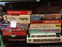Photo of stacked vintage board games and puzzles showing their titles.