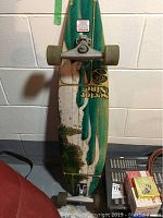 Photo of 40 inch green and white longboard skateboard with visible trucks and wheels.