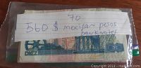 Plastic bag containing 560 Mexican pesos banknotes with various denominations, visible 10 peso note