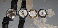 All four watches laid out side by side