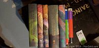 Photo of the full set of Harry Potter hardcover books showing the spines and front covers arranged on a surface.