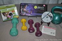 Photo of entire lot showing weights, kettlebell, DVDs and boxed kits