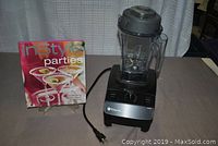 Overview of blender assembled with cookbook on stand behind