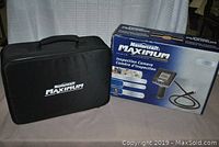 Zippered soft carrying case alongside original retail box on table