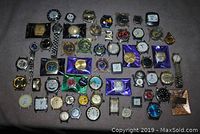 Wide shot of all 48 vintage watches laid out on a fabric surface showing variety in styles and sizes.