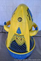 Front view of yellow and blue "Bombardier" SeaDoo underwater scooter showing ergonomic side handles, blue mesh cage lower section, and branding decals.