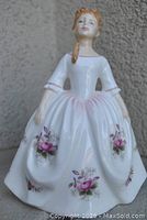 Front view of Royal Doulton Lavender Rose figurine showing rose floral design and sculpted detail of face and dress.