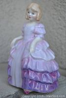 Front angle of 'Rose' figurine showing detailed dress and face features.