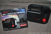 Air compressor with box showing front view of the unit and packaging.