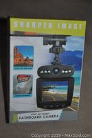 Front of the product box showing the dashboard camera with images representing video recording and accident capture, highlighting ultra wide angle and HD video features.