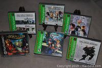 Photo showing six PlayStation Greatest Hits video games arranged with cases visible including Final Fantasy series, Chrono Cross, and The Legend of Dragoon.