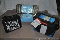 Photo of entire lot showing three fabric coolers and lunch bags in different colors and patterns placed on a cloth surface