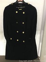 Front view of navy blue ladies jacket showing double-breasted gold-tone buttons, shoulder epaulettes, and buttoned cuffs.