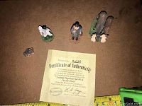 Image showing all figurines including two cats, two moose, a son figure, small animals, and a Certificate of Authenticity.