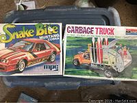 Photo showing both model kit boxes: Snake Bite Mustang Cobra by MPC and Garbage Truck by Monogram.