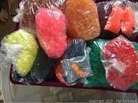 Large assorted bags of brightly colored crafting beads of various shapes and sizes.