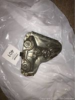 Hinged metal chocolate mould closed, showing the Easter bunny in car design in relief