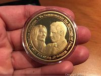 Gold plated coin showing portraits of Prince William and Catherine Middleton with commemorative text