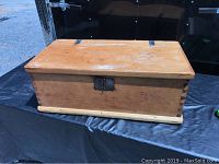 Front and top view of the antique pine blanket box showing dovetailed corners and old hardware latch plate.