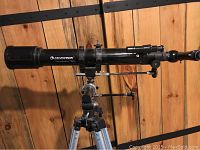 Side angle view of Celestron Power Seeker 70EQ telescope tube mounted horizontally with eyepiece and focuser details visible, shows condition and model markings.