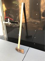 Full view of the wood splitting axe showing the entire 35 inch wooden handle and metal axe head.