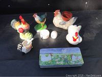 Photo of entire chicken and rooster lot including all figurines, egg shakers, creamer and decorative tin box