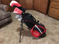 Full view of the golf bag with stand showing black and red color scheme and MacGregor logo