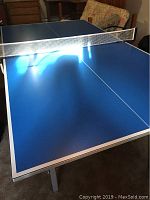 Blue ping pong table assembled with net installed