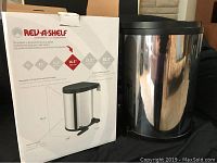 Garbage can next to its box showing dimensions and brand name