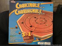 Front of sealed Crokinole Deluxe 3 in 1 wooden game set box with product image and description