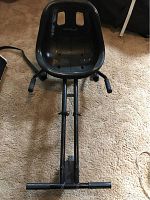 Black molded plastic seat showing bucket style design with two ventilation rectangular holes and "SmART Cart 3" branding.