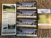 Four Smugglers Glen Golf Course green fee passes with cart and golf course brochure laid out on beige carpet