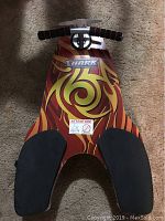 Top-down view of the Spinner Shark kneeboard showing the foam padded knee areas and vibrant swirl design.