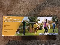 Box front showing the lot contains a volleyball and badminton set with net, rackets, shuttlecocks, and people playing.
