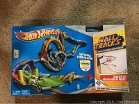 Box front showing Hot Wheels Wall Tracks Starter Set with track loop and car illustration.