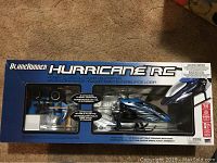 Box front view showing BladeRunner Hurricane RC helicopter and controller in packaging.