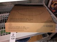 Box view showing the product name and description in multiple languages: 'Large Round Stone with Handles - 15" White'.